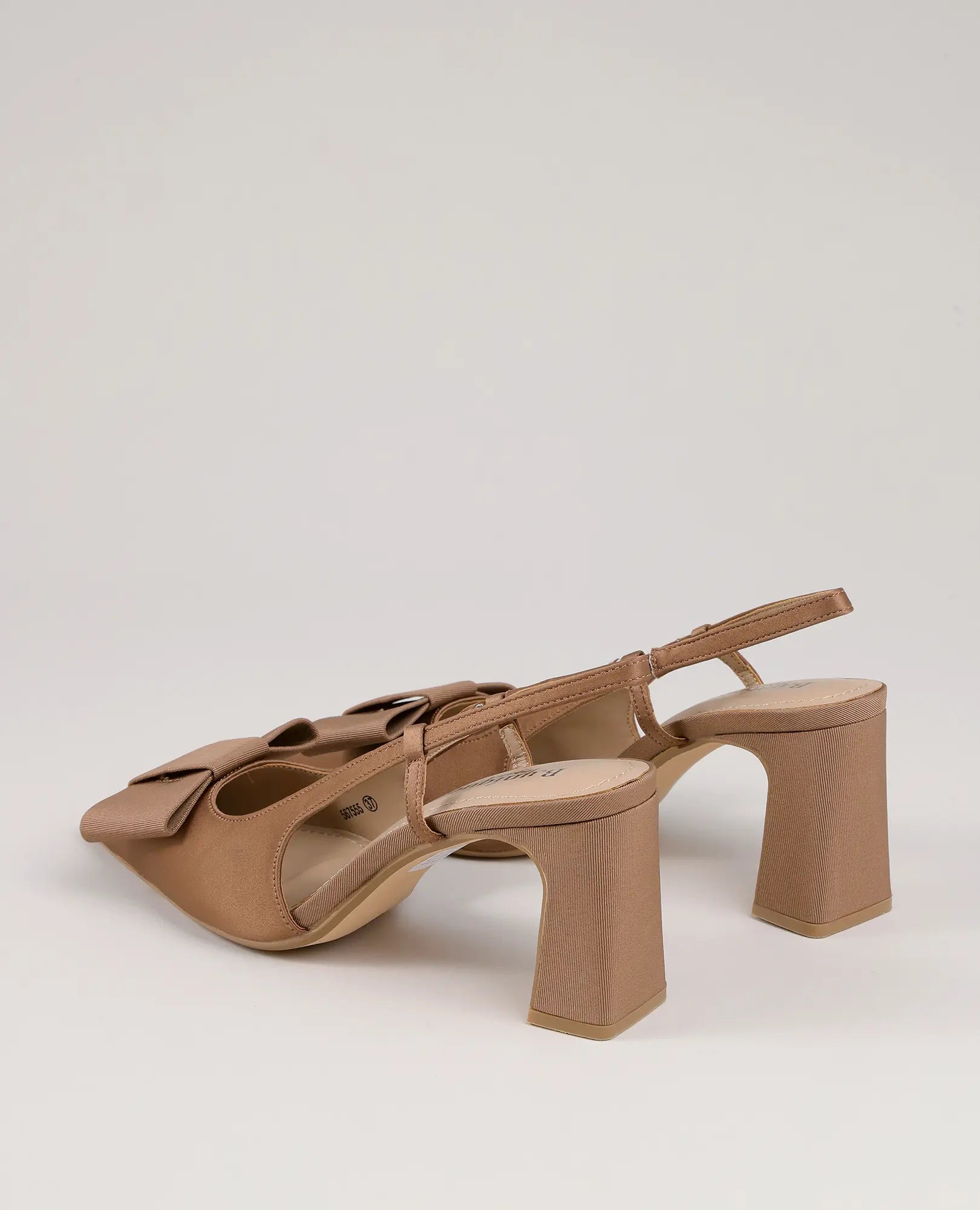 זוג סנדלי עקב "פפיון-פלא" מבית B-Unique VEGAN, סנדלי סלינגבק בצבע בז' עם קצה מחודד וקשתות על רקע חלק.