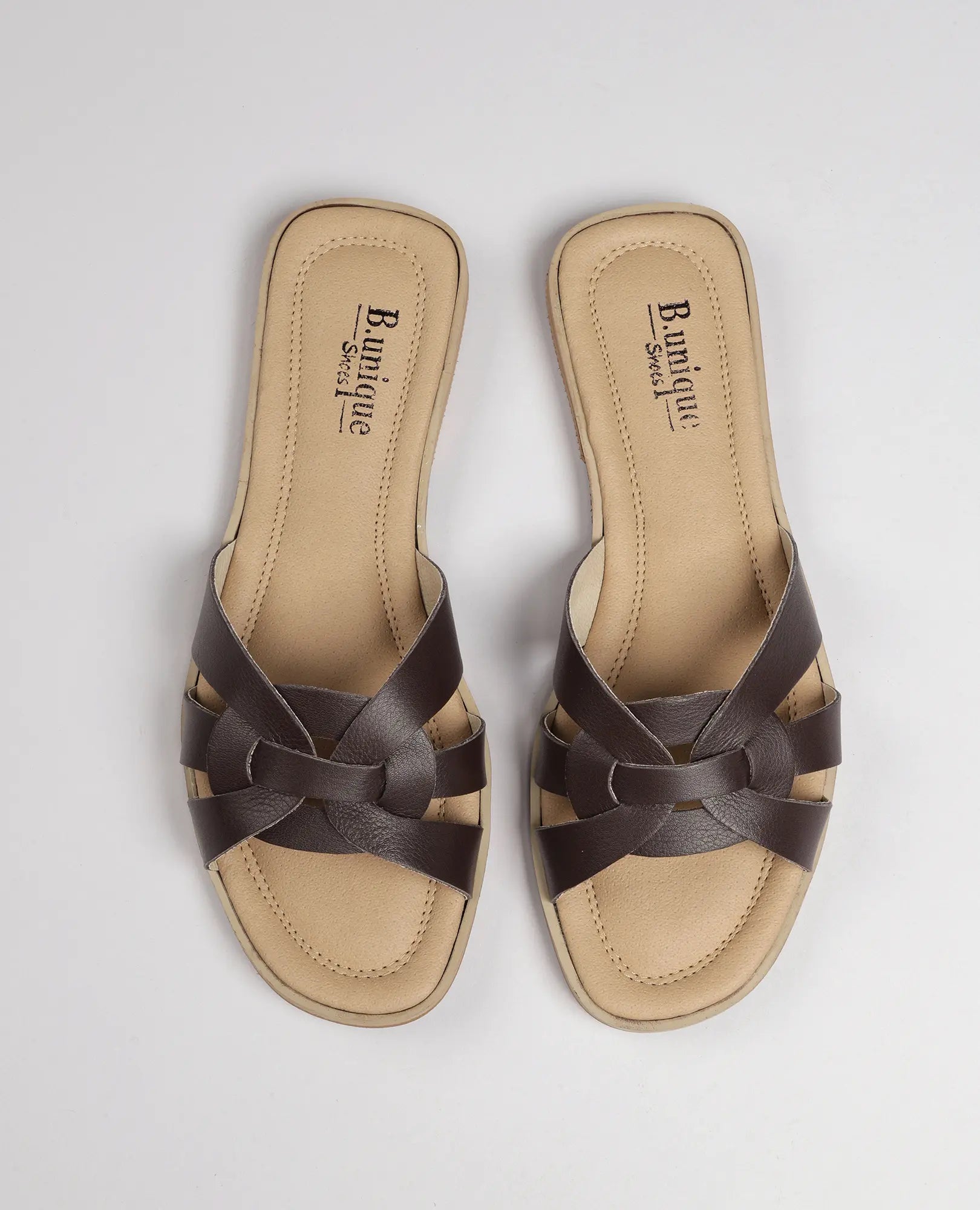 זוג כפכפי רצועות חומים מדגם "ריבר" של B.unique, עם רצועות קלועות וסוליות בצבע בז' על רקע אחיד.