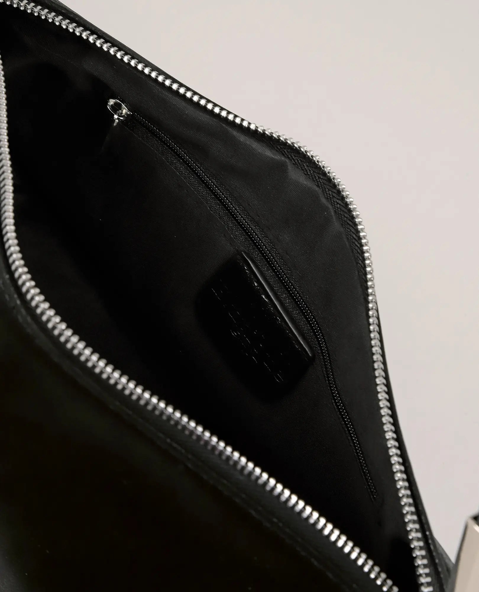 פתחו את תיק הצד המלבני "אליס" מבית B-Unique Bags ותגלו כיס עם רוכסן, בטנה חלקה ושולי רוכסן מתכתיים.